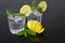 Water in a glass of ice cubes, lemon and fresh mint. Water cup for solid health. Drops of water on the cups.