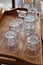 Water glasses stacked on wooden tray at cafe