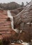 Water from a heavy rain rushes down a red sandstone slope on a cold winter day in Zion national park Utah