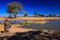 Water hole in Africa. Tipical African ladscape with dark blue sky. Water lake in Botswana. Trees with pond.