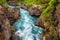 Water of Hvita river is flowing through the lava rocky canyon, amazing power of nature, Hraunfossar, Iceland