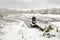 Water intake structure on the background of a pond in winter