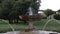 Water jets from the old antique retro fountain among the plants in the park