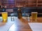 Water jug, cups, beer, brunch menus on bar counter