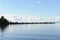 Water landscape on a summer clear day. Blue sky, clouds. Islands far away