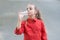 Water is life. Thirsty child drinking fresh water from plastic bottle. Little girl having a drink from water bottle