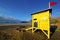 Water lifeguard chair cabin red flag rock stone sky