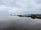 Water meets sky with rocks shoreline