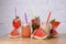 Water melon cocktails with fresh melon and boba bubble tea, on a table over white brick background.