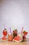 Water melon cocktails with fresh melon and boba bubble tea, on a table over white brick background.