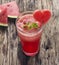 Water melon smoothie and fresh melon on wood background