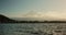 Water, mountain and waves with trees, clouds and blue sky of outdoor natural scenery in Japan. Ripples, tide and eco