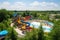 water park with colorful slides and pools, surrounded by greenery