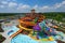 water park with colorful and whimsical water slides, including a massive spiral slide and towering wave slide