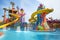 water park with colorful and whimsical water slides, including a massive spiral slide and towering wave slide