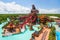 water park with themed slides and water attractions, including a pirate ship slide, giant wave slide, and waterfall