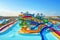 water park with vibrant and colorful slides, surrounded by blue waters