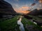 Water paths and rocks covered with green moss in Madero beach in Liencres, Cantabria at sunset