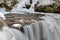 Water Plunges Over The Icy Edge Of Hoggs Falls