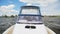 Water police speedboat sails on river against landscape blue sky