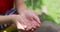 Water pours into kid's hands from the faucet. Water shortage concept