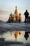 Water puddle reflection on a wet Red Square and Saint Basil Cathedral in Moscow