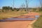 WATER PUDDLES AND HIKERS ON A ROAD IN A NATIONAL PARK