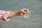 Water Purity Test. Hand holding chemical flask with liquid, lake or river in the background.