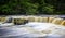 Water raging over small waterfall - long exposure