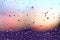 Water rain drops on the window glass on sunset. Shallow depth of field. Cityscape silhouette