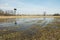 Water after rain on the meadow, trees and pulpit for hunting