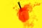 Water red background white inside under paints acrylic smoke streaks aperol spritz cocktail glass orange juice yellow