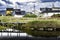 Water reflection of boardwalk bridge at Old Bay Pond with colourful Newfoundland homes and power poles at Bonavista Canada