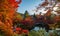 Water reflection of a bridge surrounding by five color autumn trees