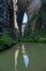 The water reflection of Qinglong Bridge in Wulong Karst, Chongqing, China, presents a serene and picturesque scene