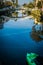 Water reflections of arched bridge over Venice canals in California