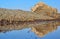 Water reflections of old construction in salt lagoon