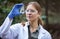 Water, research and woman scientist test in a forest for inspection of the ecosystem, sample or environment study