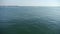 Water ripples surface.sea ocean wave.boat speeding on sea.Lighthouse on skyline.