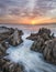 Water rushes in from the ocean during spectacular sunset.