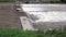 Water rushing over spillway in flooded river