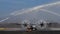 Water Salute to a Propeller Cargo Airplane Taxiing on Military Airport Runway