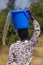 Water scarcity an african girl forced to walk long distances spills water from a bucket