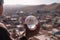 Water scarcity concept - a little boy holding a water blob, looking at a drought deserted city. Generative AI
