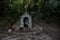 A water source in a stone arch with an Orthodox cross at the top