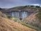 Water spilling over Meldon Dam on the West Okement River, Meldon Reservoir, Dartmoor National Park, Devon