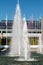 Water spray in fountain near business buildings