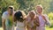 Water sprayed on excited smiling friends, young people having fun in summer