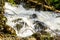 Water from the spring snow melt tumbling over Logs and Boulders on Mcgillivray Creek between Whitecroft and Sun Peaks