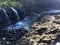 Water Stream Entering Pacific Ocean near Queen`s Bath in Princeville on Kauai Island, Hawaii.